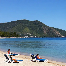 Caribbean Holidays, Cheap June Holidays, Visitors relaxing on Reduit Beach in Saint Lucia, calm water, sun loungers and green hills in the background