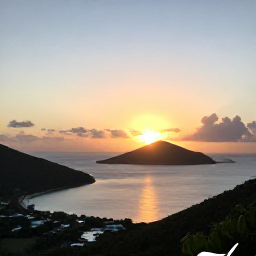 Caribbean Holidays, Cheap March Holidays, A scenic Caribbean sunset viewed from a hillside lookout, with calm sea, island silhouettes and warm evening light in the United States Virgin Islands
