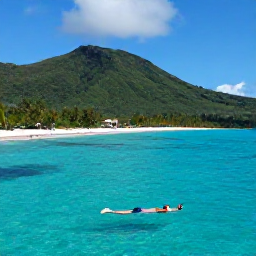 Caribbean Holidays, Cheap Nature Holidays, Budget-friendly Caribbean beach beside green hills, with a snorkeller in clear turquoise water