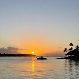 Caribbean Holidays, Cheap October Holidays, Sunset over a quiet United States Virgin Islands harbour, with a small boat on the water and palm trees in silhouette