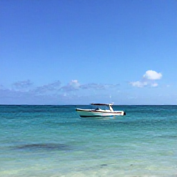 Caribbean Holidays, Cuba Diving August, A small dive boat approaching a calm turquoise bay on Cuba&rsquo;s Caribbean coast under a sunny August sky