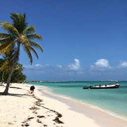 Caribbean Holidays, Cuba Scuba Diving, White Cuban beach with calm turquoise sea, palm trees and a small dive boat on the horizon