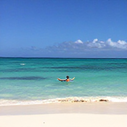 Caribbean Holidays, Cuba Solo Holidays, A relaxed solo traveller swimming in clear turquoise water beside a white sandy beach in Varadero, Cuba