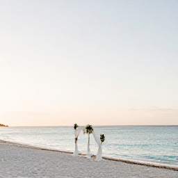 Caribbean Holidays, Cuba Wedding August, Quiet Cuban beach at sunrise in August, with white sand, calm turquoise water and a small wedding arch