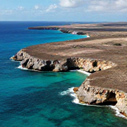Caribbean Holidays, Cura&ccedil;ao Adventure Holidays, Aerial view of Cura&ccedil;ao's rugged coastline, turquoise sea, limestone cliffs and dry Caribbean landscape in bright natural light