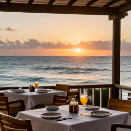 Caribbean Holidays, Curacao Beach Holidays, Relaxed beachfront restaurant in Curacao at sunset with Caribbean food, drinks and tables overlooking the sea