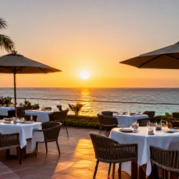 Caribbean Holidays, Cura&ccedil;ao Business Class, Elegant Cura&ccedil;ao hotel terrace at sunset with outdoor dining and views of the Caribbean Sea