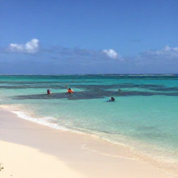 Caribbean Holidays, Cura&ccedil;ao in May, A quiet Cura&ccedil;ao beach in May with clear shallow water, pale sand and snorkellers near a coral reef