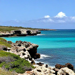 Caribbean Holidays, Cura&ccedil;ao in May, A sunny Cura&ccedil;ao coastline in May with turquoise water, rugged rocks and low green vegetation