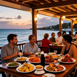 Caribbean Holidays, Cura&ccedil;ao in May, Cura&ccedil;ao seaside restaurant at sunset with fresh seafood, colourful local dishes, warm lights and relaxed holiday diners