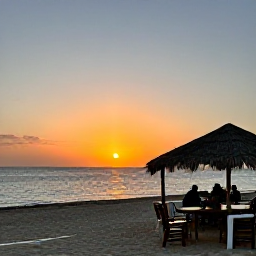Caribbean Holidays, Cura&ccedil;ao in October, A sunset over the Cura&ccedil;ao coast with warm evening light, calm sea and a relaxed beachfront restaurant atmosphere