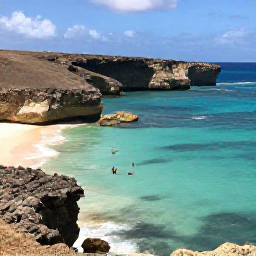 Caribbean Holidays, Cura&ccedil;ao Instagram Hotspots, Rugged coastline and bright turquoise sea at Playa Lagun in Cura&ccedil;ao, with snorkellers, cliffs and clear December sunshine