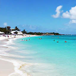 Caribbean Holidays, Cura&ccedil;ao June Holidays, Cura&ccedil;ao beach scene in June with visitors snorkelling in clear turquoise water beside a sheltered sandy cove
