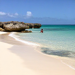 Caribbean Holidays, Cura&ccedil;ao Nature Holidays, A quiet Cura&ccedil;ao beach with clear shallow water, pale sand, rocky headlands and a snorkeller exploring near the shore