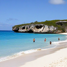 Caribbean Holidays, Curacao Nature Holidays, Calm turquoise water, white sand and limestone cliffs at Playa Kenepa on Cura&ccedil;ao, with snorkellers near the shore