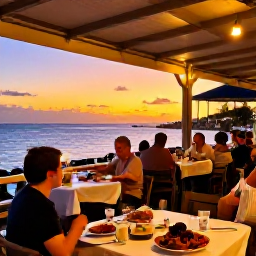 Caribbean Holidays, Curacao Tours, Friendly outdoor Cura&ccedil;ao restaurant at sunset, local dishes on tables, warm lights and relaxed diners near the sea