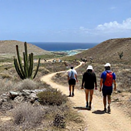 Caribbean Holidays, Cura&ccedil;ao Walking Holidays, Hikers following a scenic trail through Cura&ccedil;ao&rsquo;s dry countryside, with cacti, rocky hills and distant Caribbean views