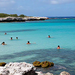 Caribbean Holidays, Curacao Wellness, Visitors swimming and snorkelling in clear Caribbean water near a quiet Cura&ccedil;ao cove, with colourful fish and rocky coastline