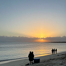 Caribbean Holidays, December Fishing, A peaceful Caribbean sunset over a Turks and Caicos beach with fishing gear, a cooler and a small group enjoying the end of the day