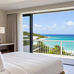 Caribbean Holidays, December Honeymoons, Elegant honeymoon hotel suite overlooking the Caribbean Sea in Saint Kitts, with white linens, balcony and tropical greenery