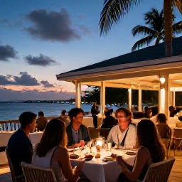 Caribbean Holidays, December Spa Breaks, Elegant evening dining terrace in Gustavia with warm lights, relaxed guests and a Caribbean sunset