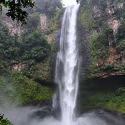 Caribbean Holidays, Dominica Adventure Holidays, Adventurous trek through Dominica's tropical rainforest towards a tall waterfall with mist in the air