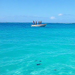 Caribbean Holidays, Dominica All Inclusive, Snorkellers and a small boat exploring clear blue Caribbean water near Dominica, with colourful tropical fish below the surface