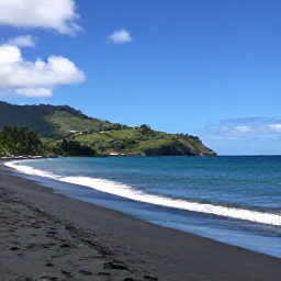 Caribbean Holidays, Dominica Beach Holidays, Wide view of Mero Beach in Dominica with black volcanic sand, turquoise Caribbean Sea and green hills in the background