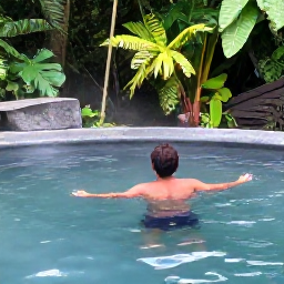 Caribbean Holidays, Dominica December, Backpacker swimming in a warm natural hot pool near rainforest in Dominica