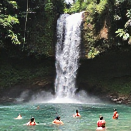 Caribbean Holidays, Dominica in April, A peaceful Dominica waterfall surrounded by tropical foliage, with visitors swimming in a clear natural pool