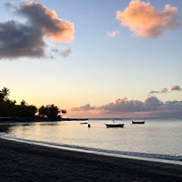 Caribbean Holidays, Dominica in June, Quiet Dominica coastline at sunset in June, dark volcanic beach, calm Caribbean Sea, small fishing boats and travellers enjoying an authentic island evening