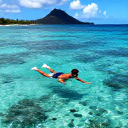 Caribbean Holidays, Dominica in May, A snorkeller exploring clear Caribbean water near Dominica, with colourful fish and volcanic coastline visible in the background