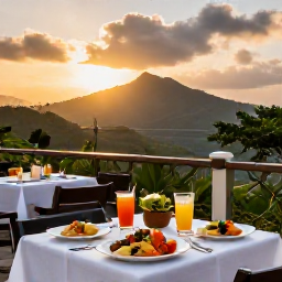 Caribbean Holidays, Dominica November, A welcoming all-inclusive resort dining terrace in Dominica at sunset, with Caribbean food, tropical drinks and distant green hills