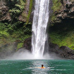 Caribbean Holidays, Dominica Solo Holidays, Solo visitor swimming in the warm emerald waters of Trafalgar Falls, surrounded by Dominica rainforest in June