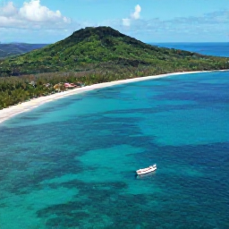 Caribbean Holidays, Dominican Adventure, Aerial view of the Dominican Republic coastline in November, with turquoise water, green hills and a small adventure boat