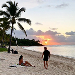 Caribbean Holidays, Dominican December Adventures, Friendly travellers relaxing at a Dominican Republic beach after an active day, with a sunset over calm sea and palm trees