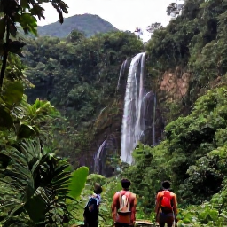 Caribbean Holidays, Dominican December Adventures, Travellers hiking through lush green Dominican Republic countryside towards a waterfall, with tropical plants and distant mountains