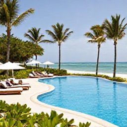 Caribbean Holidays, Dominican Republic Couples Holidays May, An elegant beachfront resort in Punta Cana with a swimming pool, tropical gardens and couples relaxing beneath palm trees
