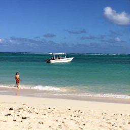 Caribbean Holidays, Dominican Republic October, White sand beach near Punta Cana with clear Caribbean water, a small boat offshore and travellers enjoying a gentle October day