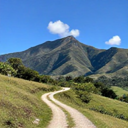 Caribbean Holidays, Dominican Walking, A scenic mountain walking trail through green countryside near Jarabacoa, Dominican Republic, with distant peaks and a clear blue sky
