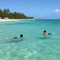 Caribbean Holidays, February Beach Holidays, Visitors swimming and snorkelling in clear turquoise water off the Dominican Republic coast, colourful fish, warm February sunshine and a sandy beach nearby