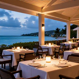 Caribbean Holidays, February Escapes, Elegant adults-only resort restaurant in Saint Kitts, outdoor tables, Caribbean dishes and soft evening lighting