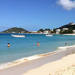 Caribbean Holidays, February Holidays, Clear Caribbean sea and sandy beach at Orient Bay, Saint Martin, with small boats and visitors enjoying the sunshine