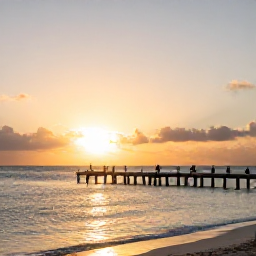 Caribbean Holidays, February Holidays, Golden sunset over a quiet Turks and Caicos beach, with calm sea, wooden jetty and visitors enjoying the peaceful February evening