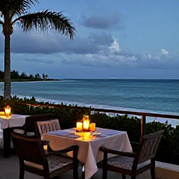 Caribbean Holidays, February Honeymoons, Romantic beachfront restaurant in Turks and Caicos at dusk, table for two with candles and a view of the sea