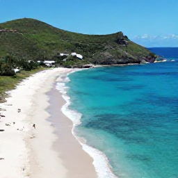 Caribbean Holidays, February Instagram Spots, Aerial-style view of Colombier Beach in Saint Barth&eacute;lemy on a clear February day, secluded white sand beach, green hills and vivid blue sea