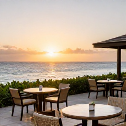 Caribbean Holidays, February Luxury Holidays, Elegant luxury hotel terrace overlooking the Caribbean Sea at sunset on Bonaire, stylish outdoor seating, gentle sea breeze and soft golden light