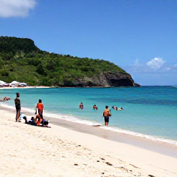 Caribbean Holidays, February Martinique, Visitors swimming and relaxing on a beautiful sandy beach in Martinique, with turquoise water, green hills and February sunshine