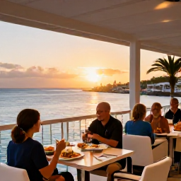 Caribbean Holidays, February Spa Breaks, A stylish waterfront restaurant in Sint Maarten at sunset, with diners enjoying Caribbean food and views of the harbour