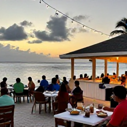 Caribbean Holidays, February Tours, A friendly beachfront restaurant on Jost Van Dyke at sunset, with outdoor tables, local food and guests enjoying a relaxed Caribbean evening